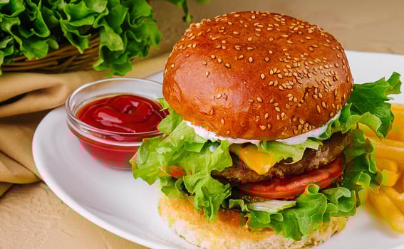 cheeseburger with french fries and ketchup on plate photo