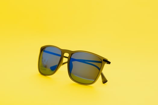 Stylish sunglasses on a yellow background High quality photo Sunglasses.