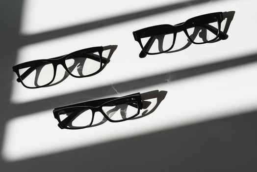 Poster of glasses on pastel background. Optics. Vision. photo