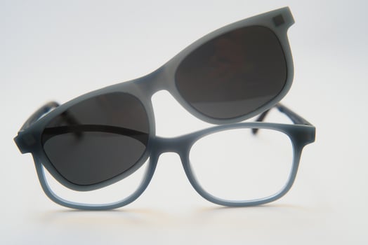 Stylish sunglasses shot using pink and blue abstract colored lighting with copy space. photo