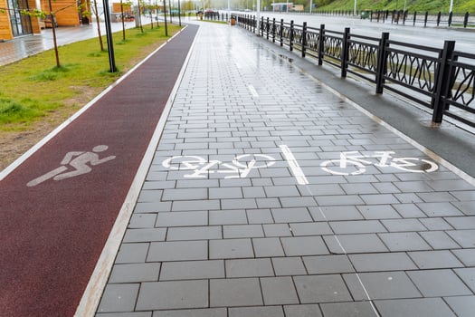 City park pavement markings bike path, treadmill on asphalt, red carpet for jogging, place for cycling, road sign photo