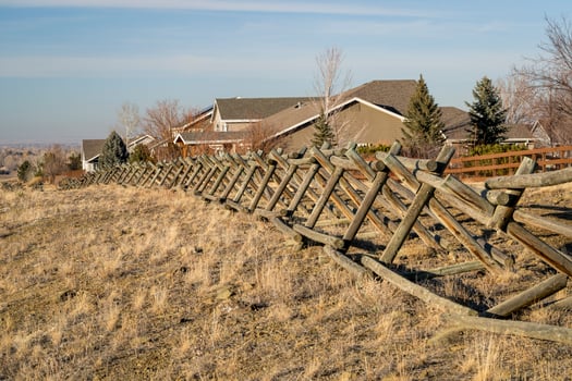 wooden fence and dirt trail along a residential area at Colorado foothills photo