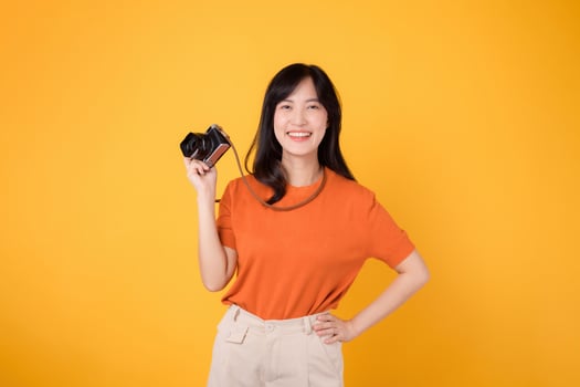 Tourist asian woman with camera, capturing the beauty of her holiday adventure. Joyful travel memories. photo