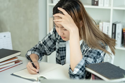 Asian student woman have anxiety because of exams, female prepare for test and learning lessons in the library. stress, despair, haste, misunderstanding reading, discouraged, expectation, knowledge photo