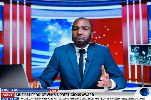 Reporter announces musical award winner on live television program, talking about talented artist and praising his music in newsroom. Media journalist hosting entertainment segment on newscast. photo