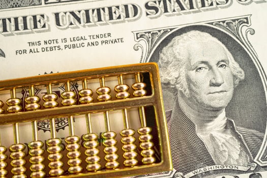 Gold abacus on USA dollar banknote money, economy finance exchange trade investment concept. photo