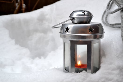 Candle lantern on the snowdrift. Cold season. Hygge style. Beautiful winter background. photo