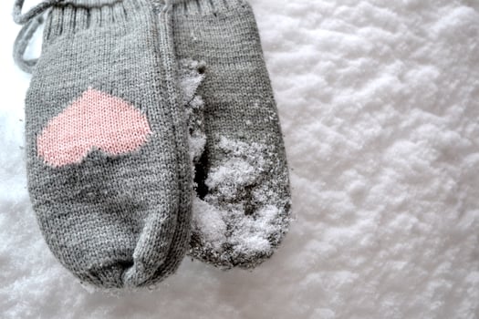 Winter woolen textile. Scarf and mittens on the snow. Beautiful winter background. Cold season. photo