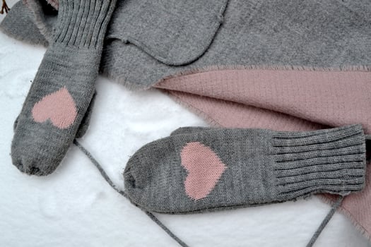 Winter woolen textile. Scarf and mittens on the snow. Beautiful winter background. Cold season. photo