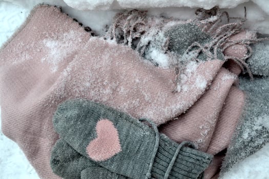 Winter woolen textile. Scarf and mittens on the snow. Beautiful winter background. Cold season. photo