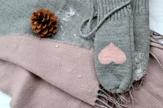 Winter woolen textile. Scarf and mittens on the snow. Beautiful winter background. Cold season. photo