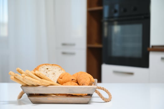 a kraft box with bread products, donuts, croissants in the kitchen photo