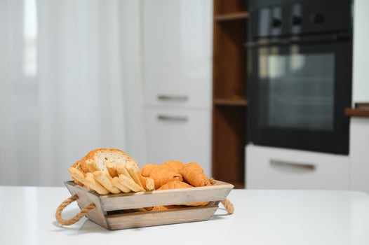 a kraft box with bread products, donuts, croissants in the kitchen photo