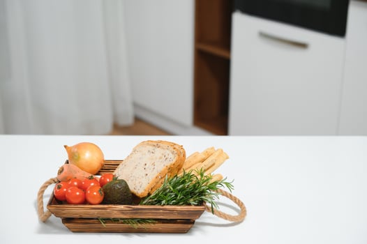 handmade kraft box with fruits and vegetables and bread from the kitchen photo