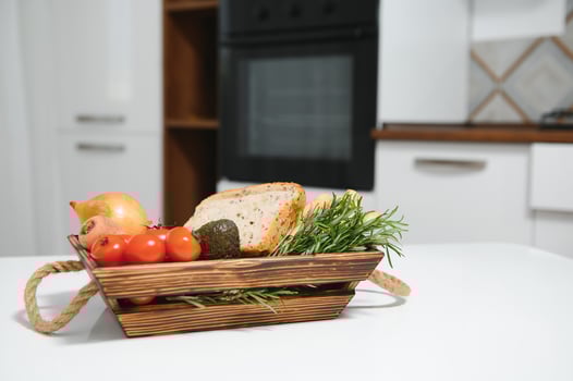 handmade kraft box with fruits and vegetables and bread from the kitchen photo