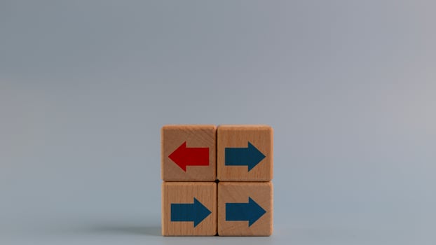 Business icons for innovative, solution, Unique, think different, and individual concepts, arrows on red wooden blocks individual pointing in different way, copy space photo