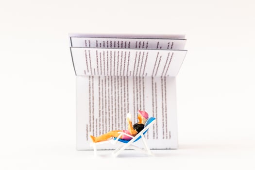 World Book Day concept, Miniature people A young woman reading a book alone photo