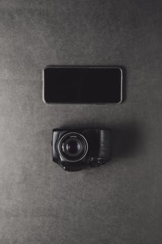 smartphone inside camera over background technology concept. photo
