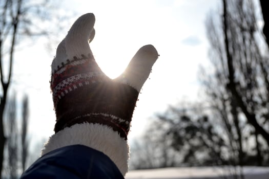 A woman's hand reaches for the sun. photo