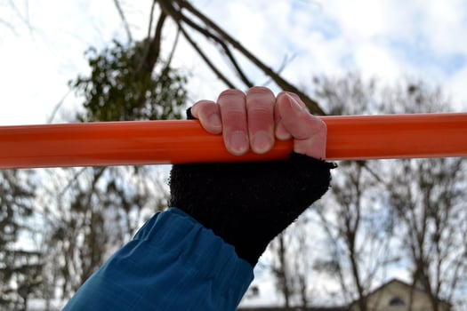 Male hands on the holizontal bar. Man is engaged in sports. photo