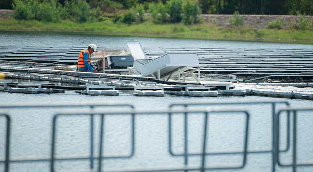 Both of technicians are currently evaluating and repairing the transmission terminals for electricity generated by solar energy in a floating solar power system. photo