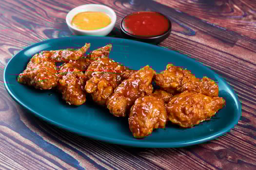 crispy chicken wings with ketchup and mayo dip served in dish isolated on background top view photo