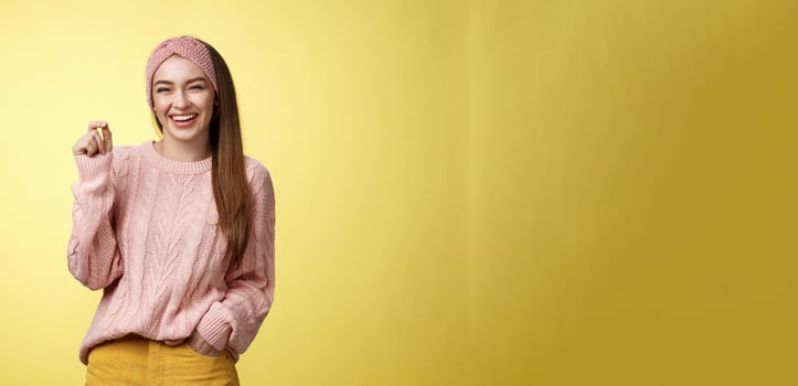 Happy carefree pleasant cute young 20s european girlfriend laughing joyfully, smiling having fun feeling positive, entertained, snap fingers gets what she wants, amused how easily dreams come true photo