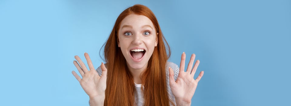 Excited charismatic happy lively redhead young funny woman smiling thrilled open mouth fascinated wide eyes surprised staring adore cool new product raise palms waving hello, show ten dozen photo