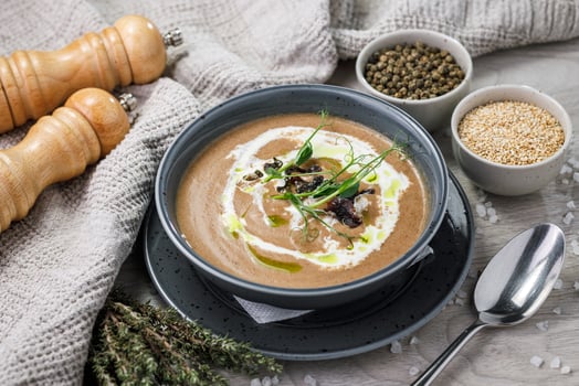Creamy mushroom cream soup with herbs and spices in a bowl photo