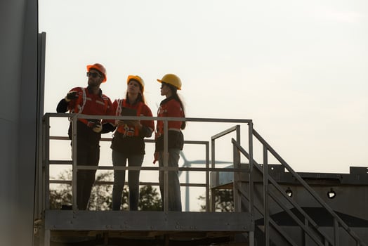 A group of engineers and architects work in floor of base ground of a wind turbine photo