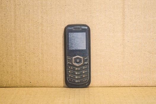 old cellphone with a plain brown background photo