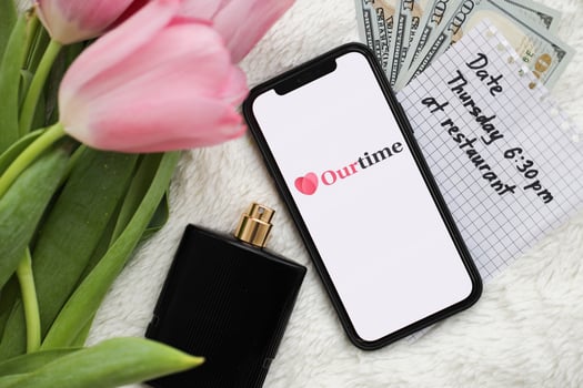 KYIV, UKRAINE - FEBRUARY 23, 2024 Our Time logo of famous dating website or app on iPhone display photo