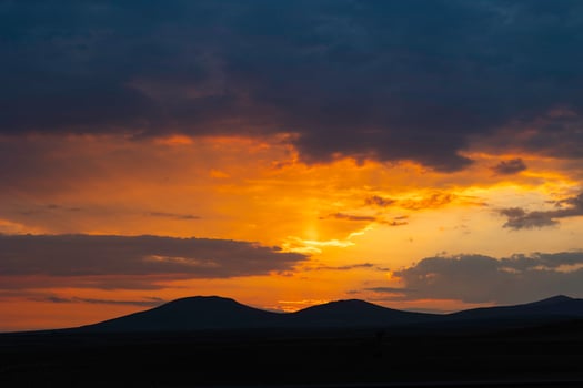 Inspirational quotes concept photo. Silhouette of hills at sunset or sunrise photo