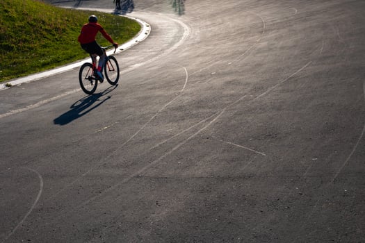 Cyclist training on the cycle-racing track at sunset. Healthy lifestyle concept photo
