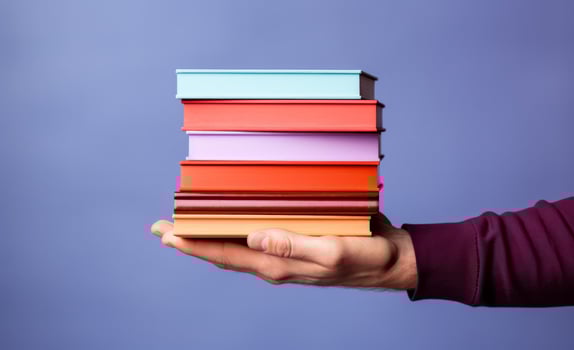 AI generated man holding stacked up book against blue background photo