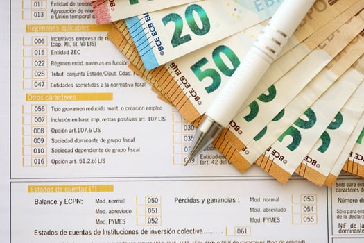 Filling italian tax form process with pen and euro money bills close up. Tax paying period photo