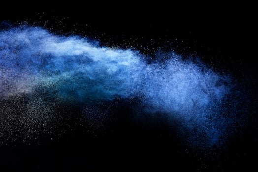 Abstract Brown Powder Explosion, Closeup of Blue Dust Particle Splash on Black Background photo