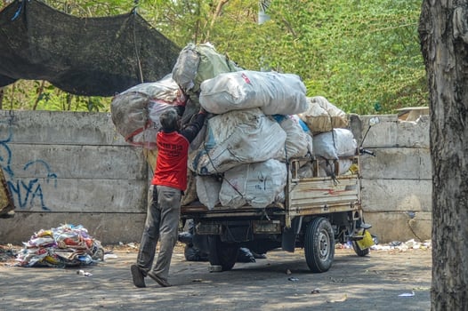a scavenger who loads rubbish into a cart, Indonesia, 2 November 2023. photo