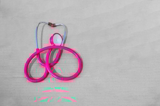 a purple stethoscope on plain cardboard photo