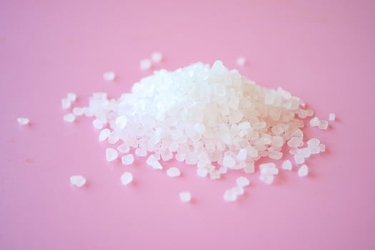Salt crystals on pink background photo