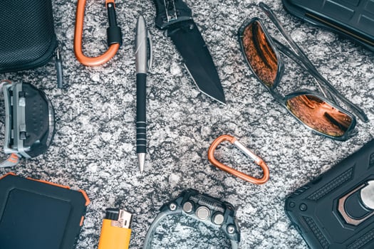 Flat lay of some Outdoor EDC gear on a grey background. photo