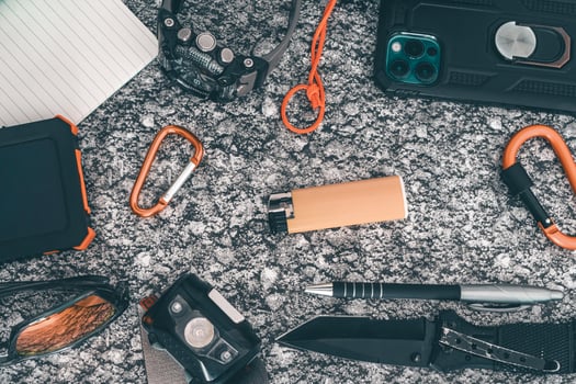 Flat lay of some Outdoor EDC gear on a grey background. photo