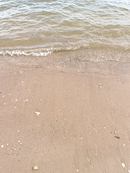 Soft wave of blue ocean on sandy beach. Background. photo
