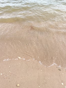 Soft wave of blue ocean on sandy beach. Background. photo