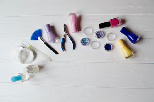 Tools for manicure on a white wooden table. photo