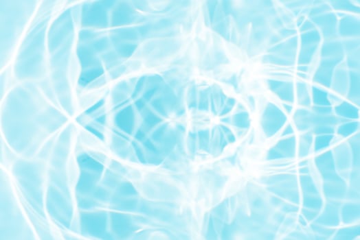 Bluewater waves on the surface ripples blurred. Defocus blurred transparent blue colored clear calm water surface texture with splash and bubbles. Water waves with shining pattern texture background. photo