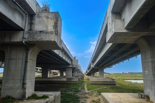 under a toll road bridge or highway with a bright blue sky photo