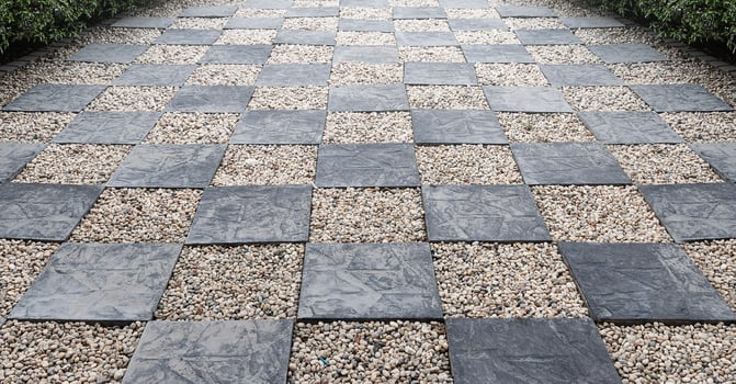 Walk way chess pattern on gravel stone floor photo