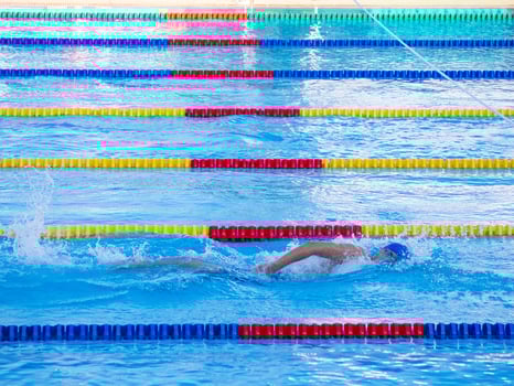 A young man swimming in an outdoor pool. Close-up photo. Concept of sport and healthcare photo