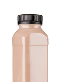 Bottle of tasty melon milkshake on white photo